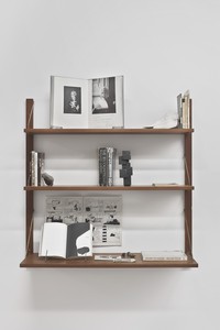 Carol Bove, Innerspace Bullshit, 2007. 14 books, comic book, letter, bronze sculpture, Marfa rock, ocean ephemera, mirror, and pamphlet on wood-and-metal shelves, 42 × 36 ⅛ × 12 inches (106.7 × 91.8 × 30.5 cm) © Carol Bove Studio LLC