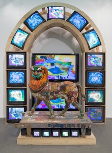 Nam June Paik, Lion, 2005. Three-channel video (color, silent) with 2 plasma monitors and 26 CRT monitors and wood lion with acrylic and permanent oil marker additions, 133 × 109 × 65 inches (337.8 × 276.9 × 165.1 cm) © Nam June Paik Estate